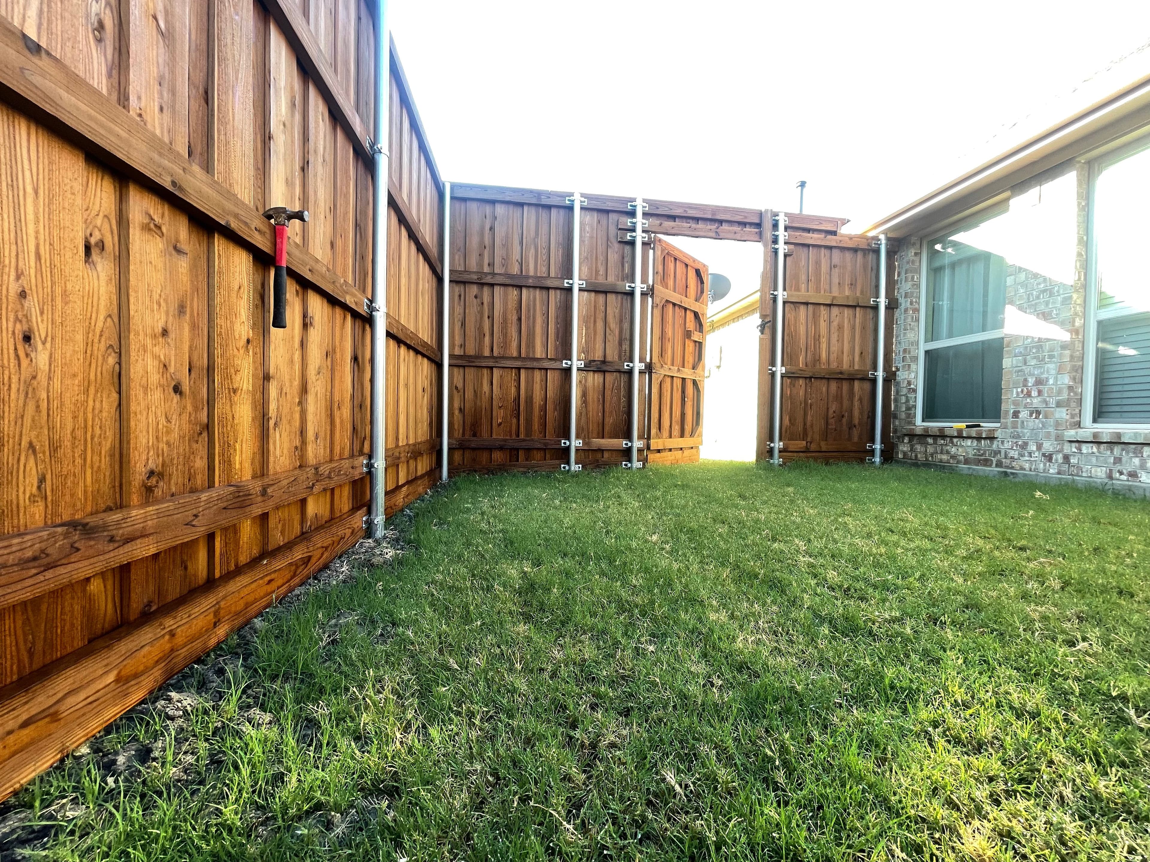 Wooden fence with gate and metal hardware