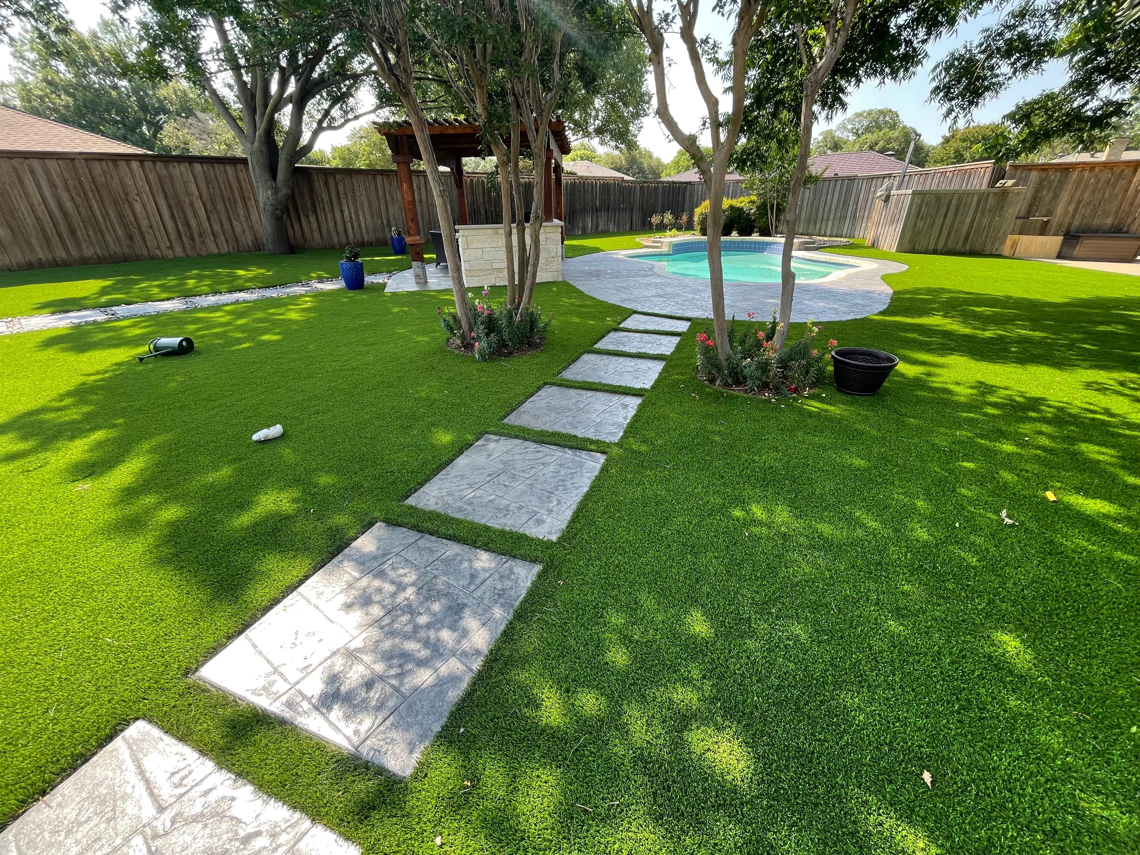 Backyard oasis with artificial turf, pool and pergola