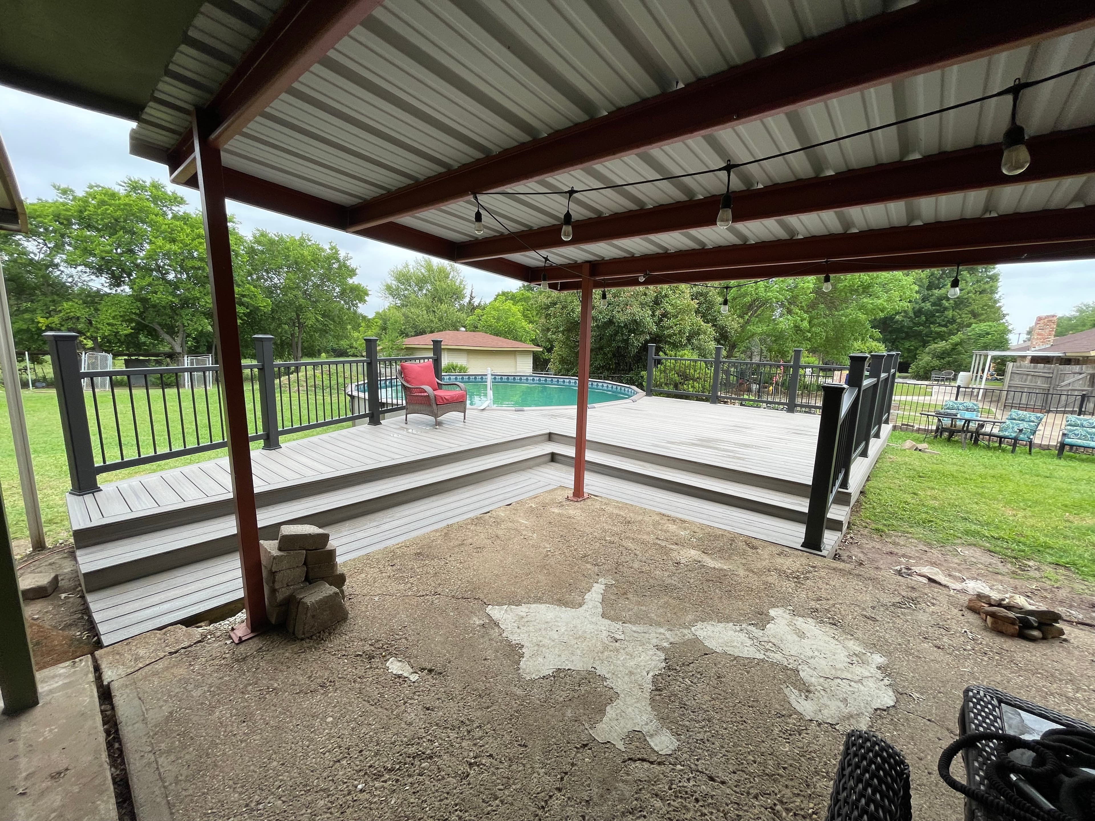 Metal patio cover with deck and pool view